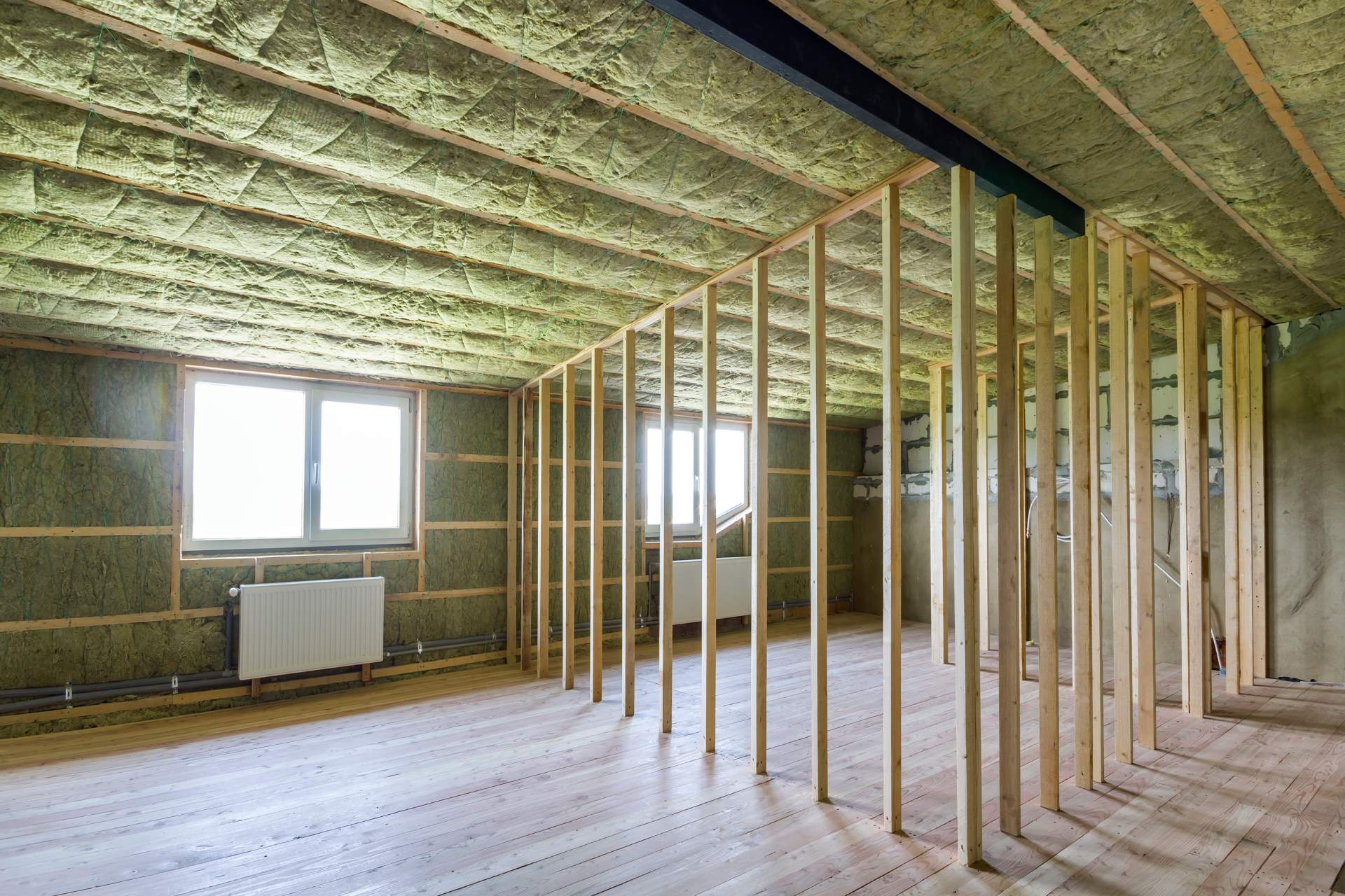 construction-renovation-big-light-spacious-empty-room-with-oak-floor-walls-ceiling-insulated-with-rock-wool-heating-radiators-low-attic-windows-wooden-frame-future-walls (1)